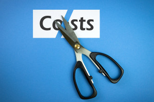 Cost cutting concept illustrated with scissors cutting the word costs on blue background